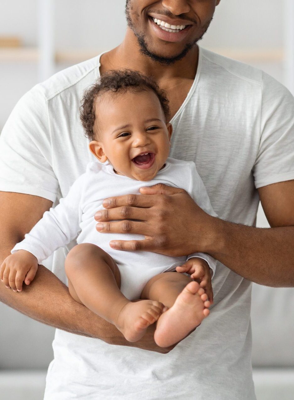 Cropped Shot Of Happy Black Father Holding His Cute Little Laughing Baby